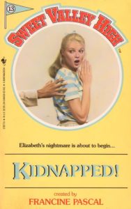 Yellow background, aqua text, usual porthole cover, with an image in the circle. The image contains Elizabeth, wearing beige slacks and a blue-and-white striped t-shirt. She is side on, looking over her shoulder in horror as an unfeasibly long wrist and hand stretches out to her. Also, the perspective is off on Elizabeth, her elbow comes down below her hip and her hand is slightly too big. All in all, an excellent example of SVH covers.