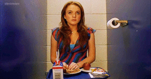 gif from Mean Girls showing Cady eating lunch alone in a toilet stall