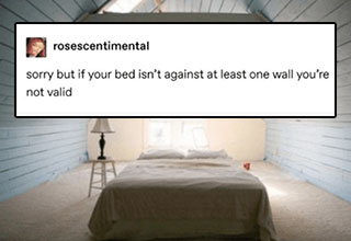 A double bed in the middle of a room, captioned "sorry but if your bed isn't against at least one wall, you're not valid".