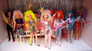 The Jem fashion doll lineup from the 80s, all dolls have neon hair; glitter, velvet or sparkly clothes; and some of them have keytars